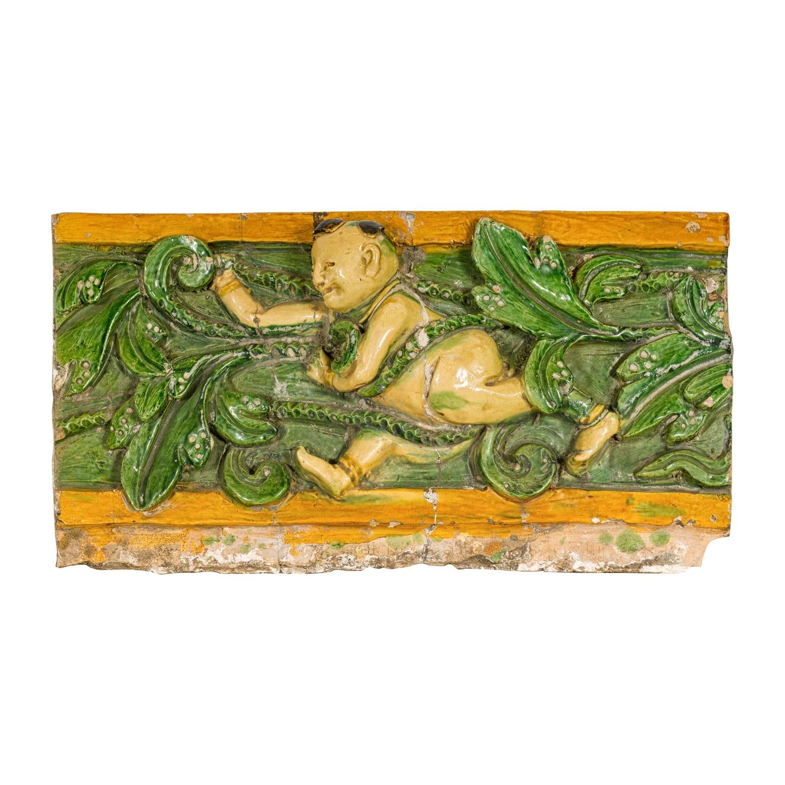 Qing Dynasty Tricolor Roof Fragment from a Temple Depicting a Boy Amidst Leaves