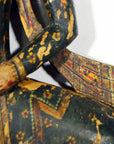 Decorative object with intricate patterns and colors on a white background