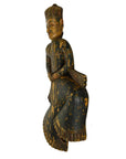 Wooden figurine of a seated figure with intricate carvings on a white background