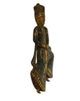 Wooden figurine of a seated figure with intricate carvings on a white background