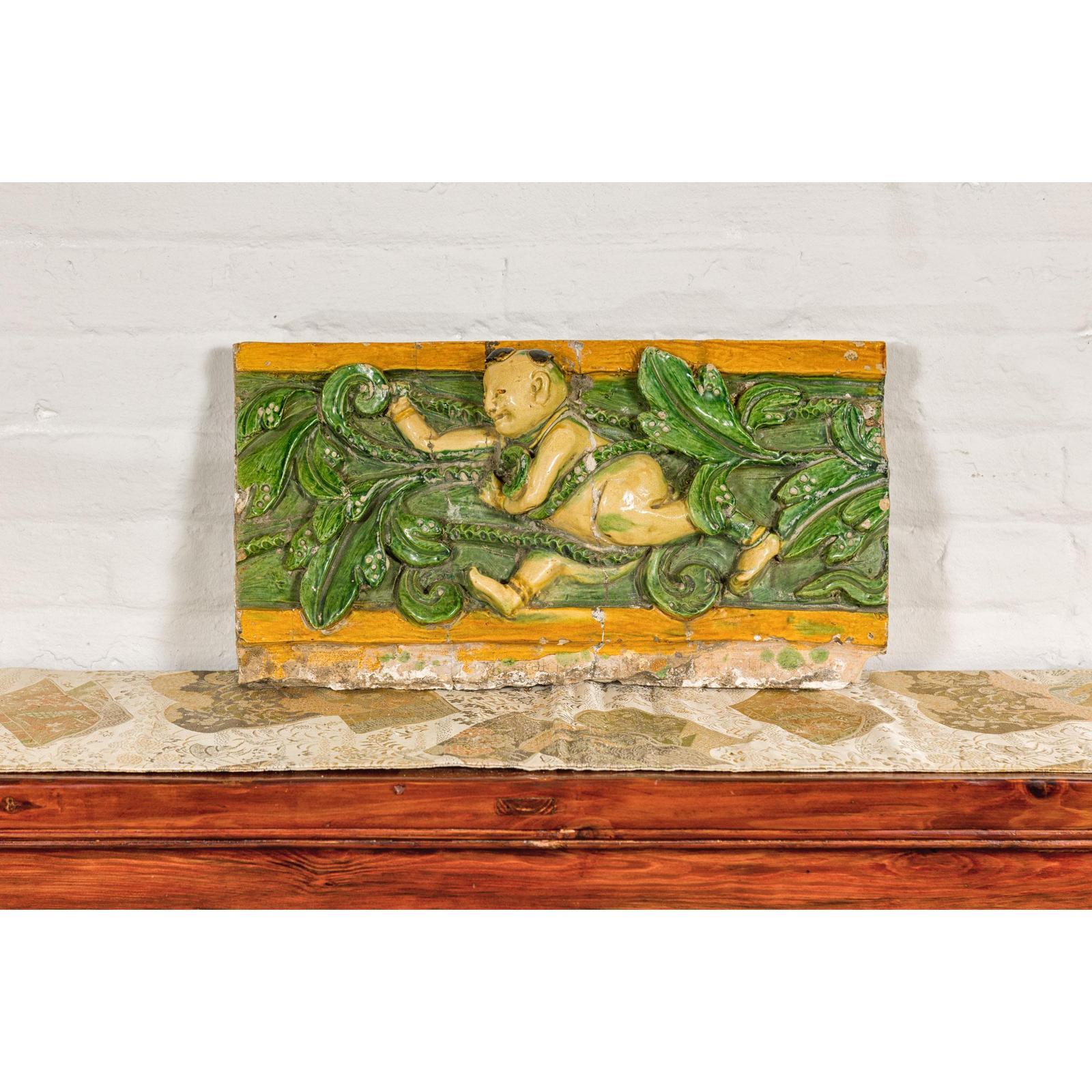 Qing Dynasty Tricolor Roof Fragment from a Temple Depicting a Boy Amidst Leaves