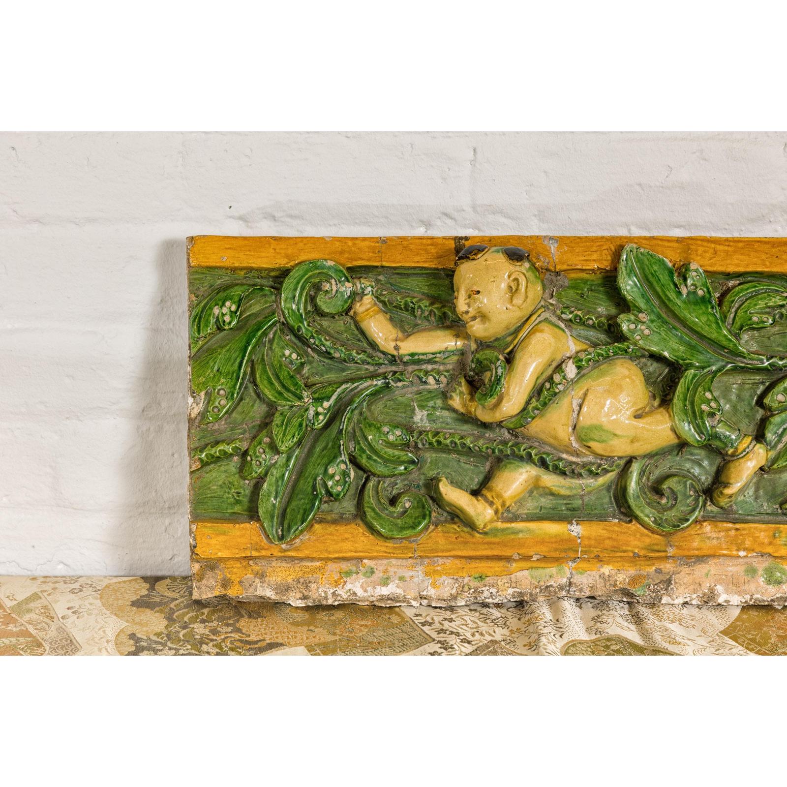 Qing Dynasty Tricolor Roof Fragment from a Temple Depicting a Boy Amidst Leaves