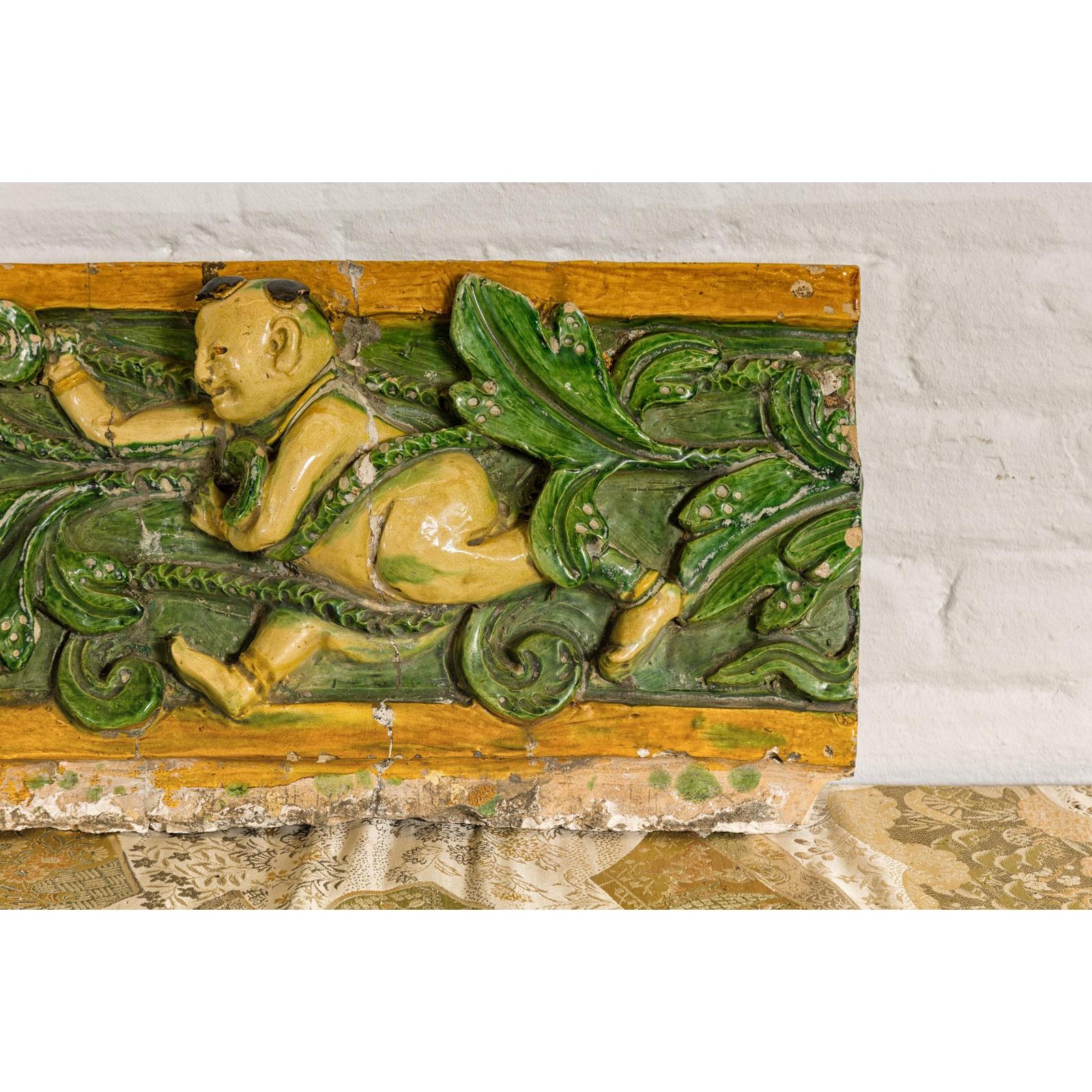 Qing Dynasty Tricolor Roof Fragment from a Temple Depicting a Boy Amidst Leaves