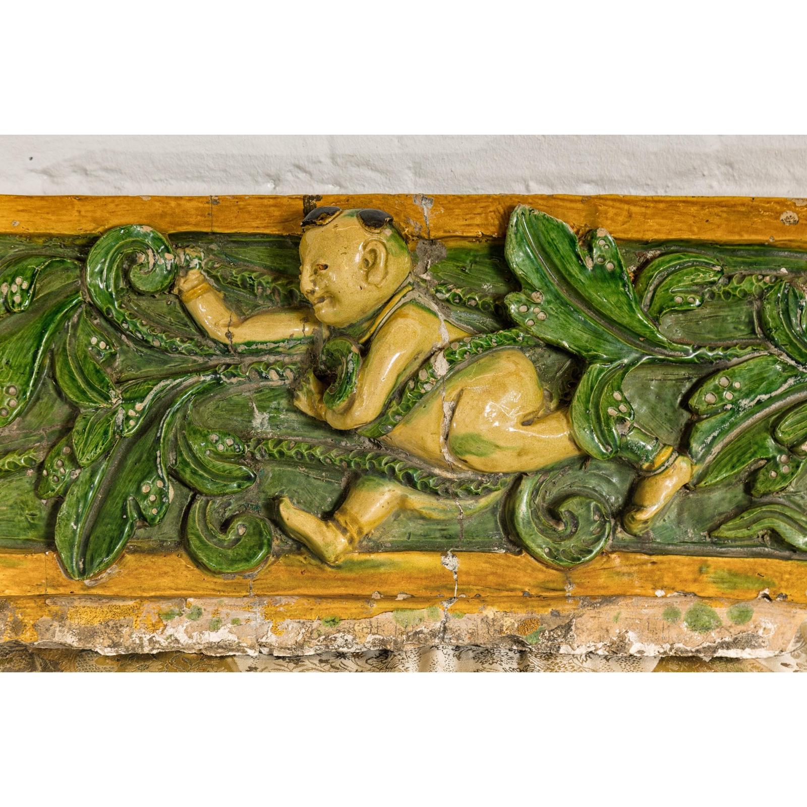 Qing Dynasty Tricolor Roof Fragment from a Temple Depicting a Boy Amidst Leaves