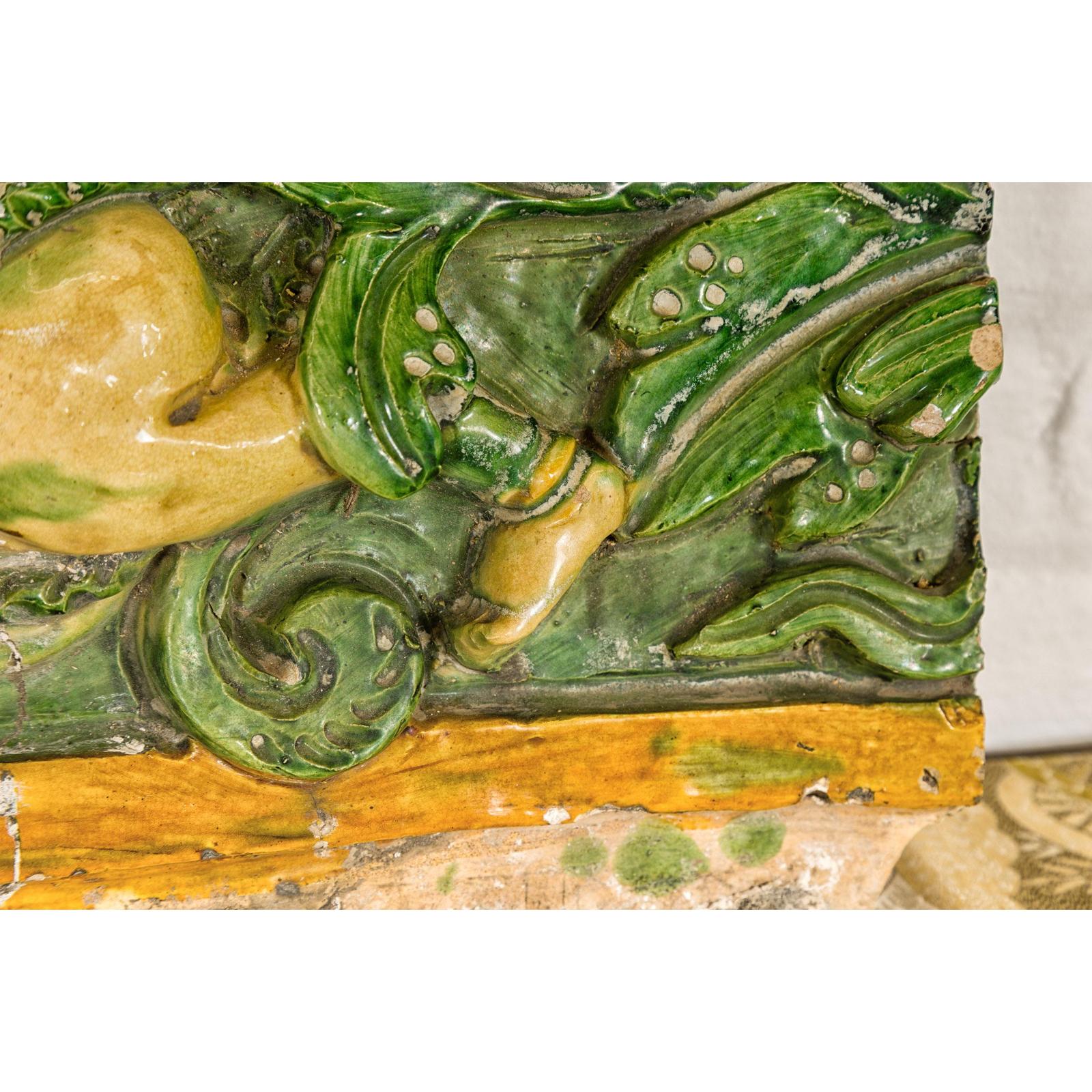 Qing Dynasty Tricolor Roof Fragment from a Temple Depicting a Boy Amidst Leaves