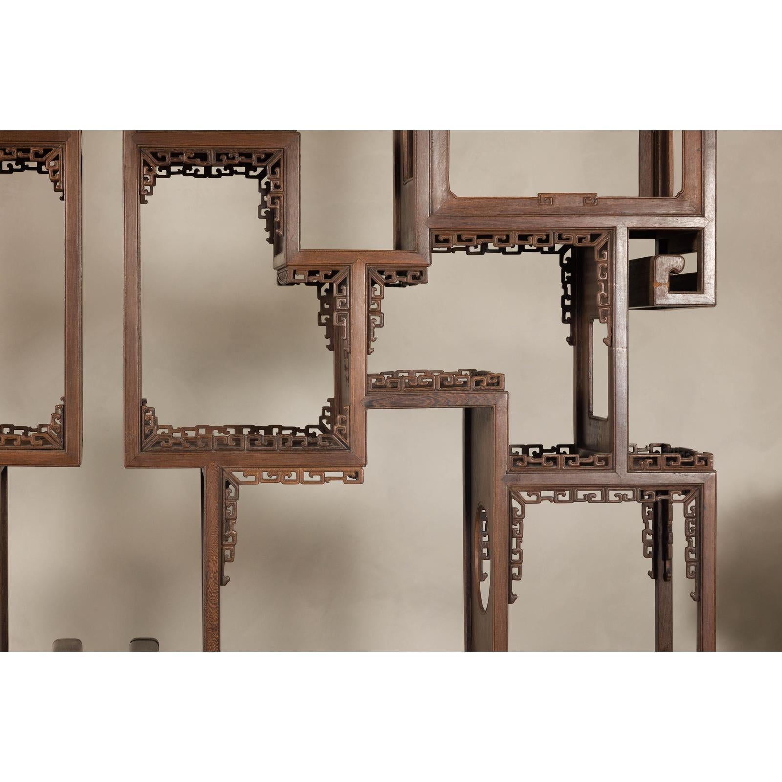 Pair of Late Qing Dynasty Brown Lacquered Display Shelves with Fretwork Motifs