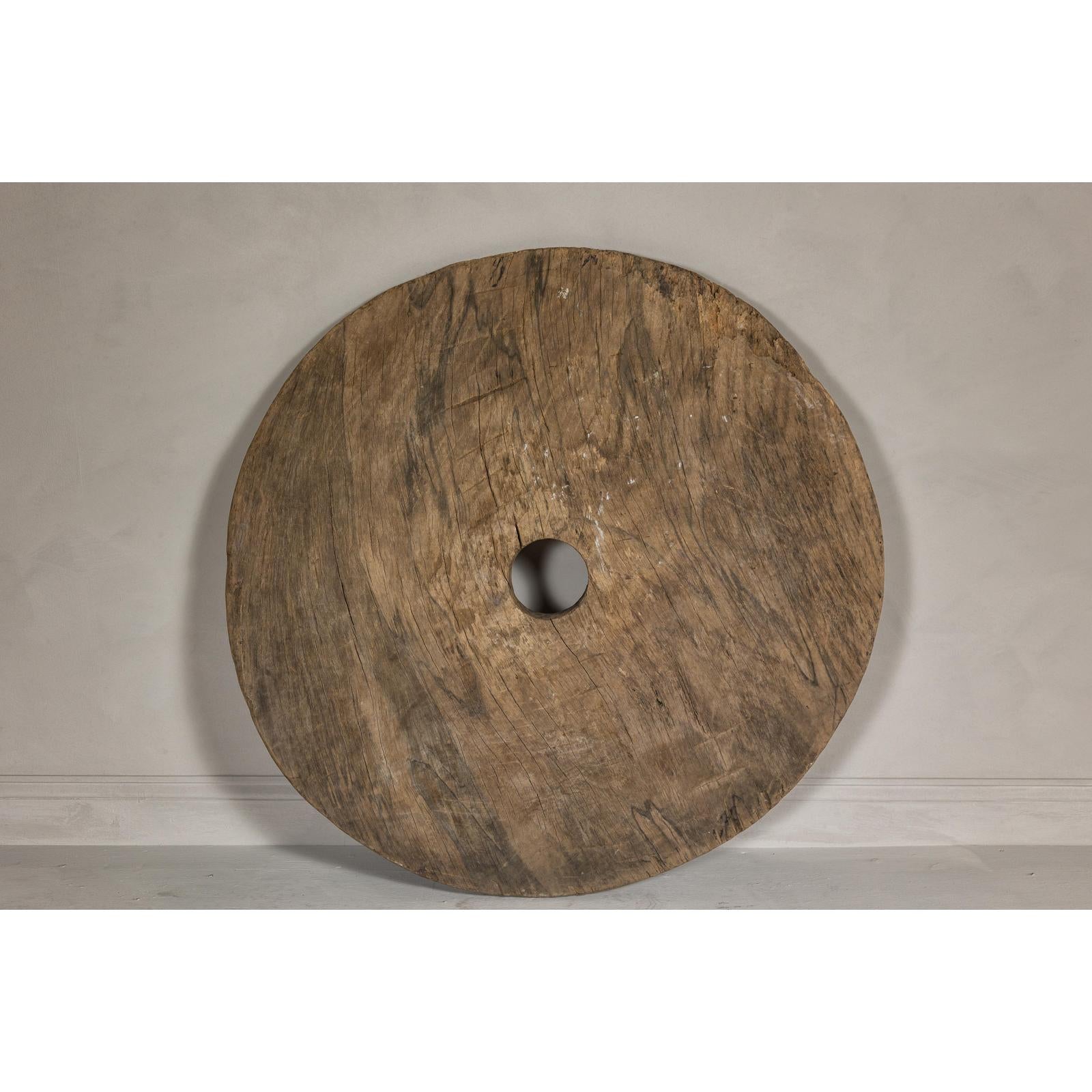 Large Ancient Cart Wheel with Rustic Character and Time-Worn Appearance