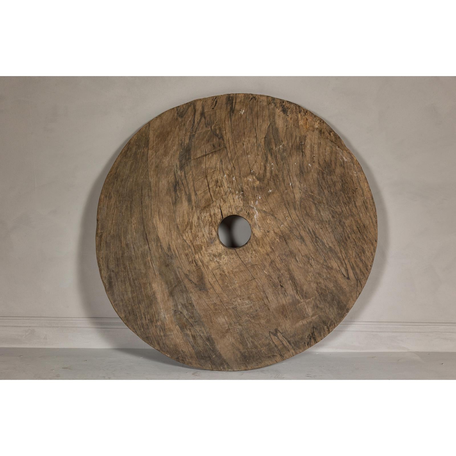 Large Ancient Cart Wheel with Rustic Character and Time-Worn Appearance