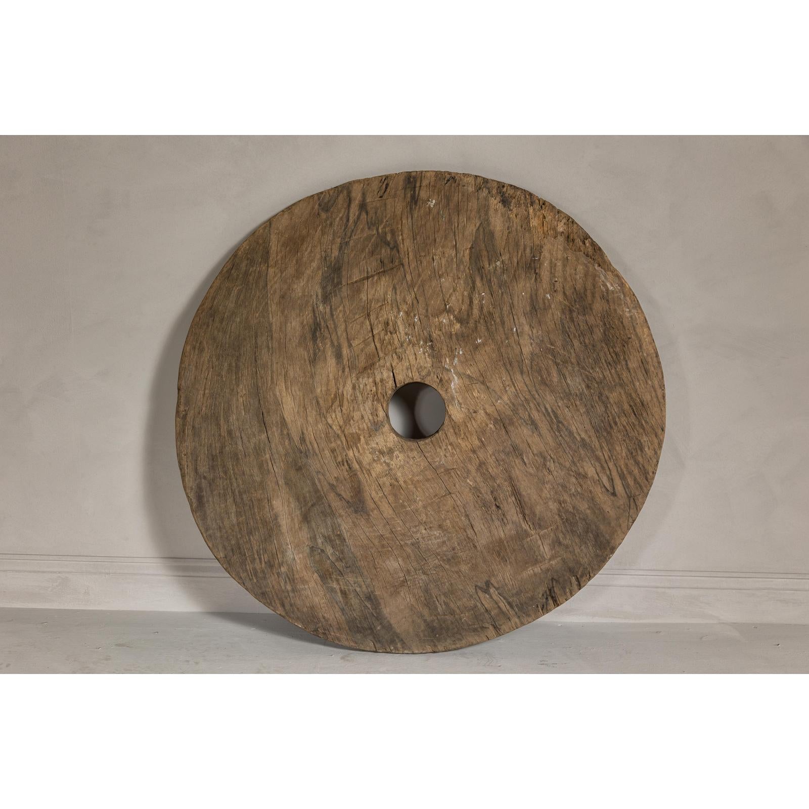 Large Ancient Cart Wheel with Rustic Character and Time-Worn Appearance