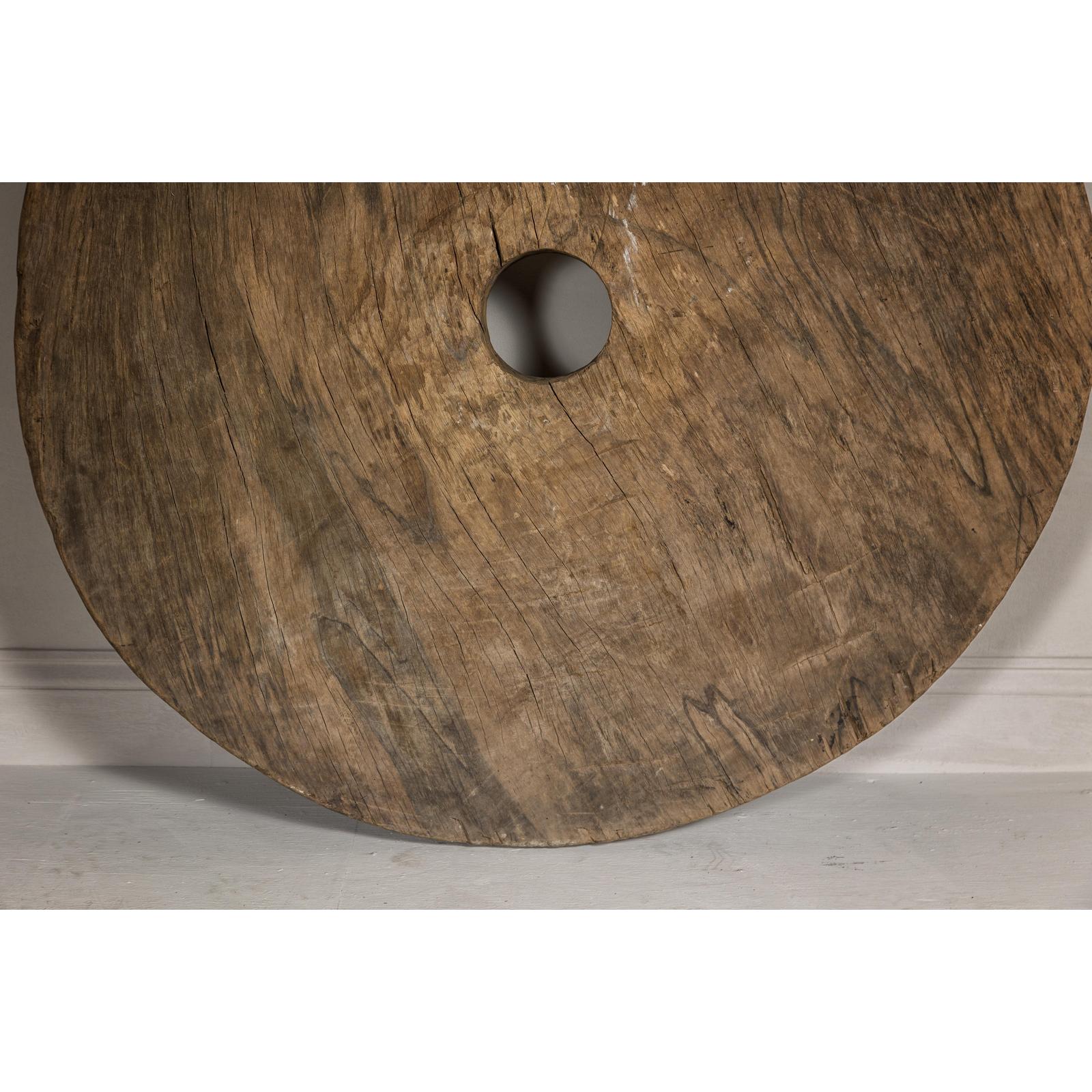 Large Ancient Cart Wheel with Rustic Character and Time-Worn Appearance