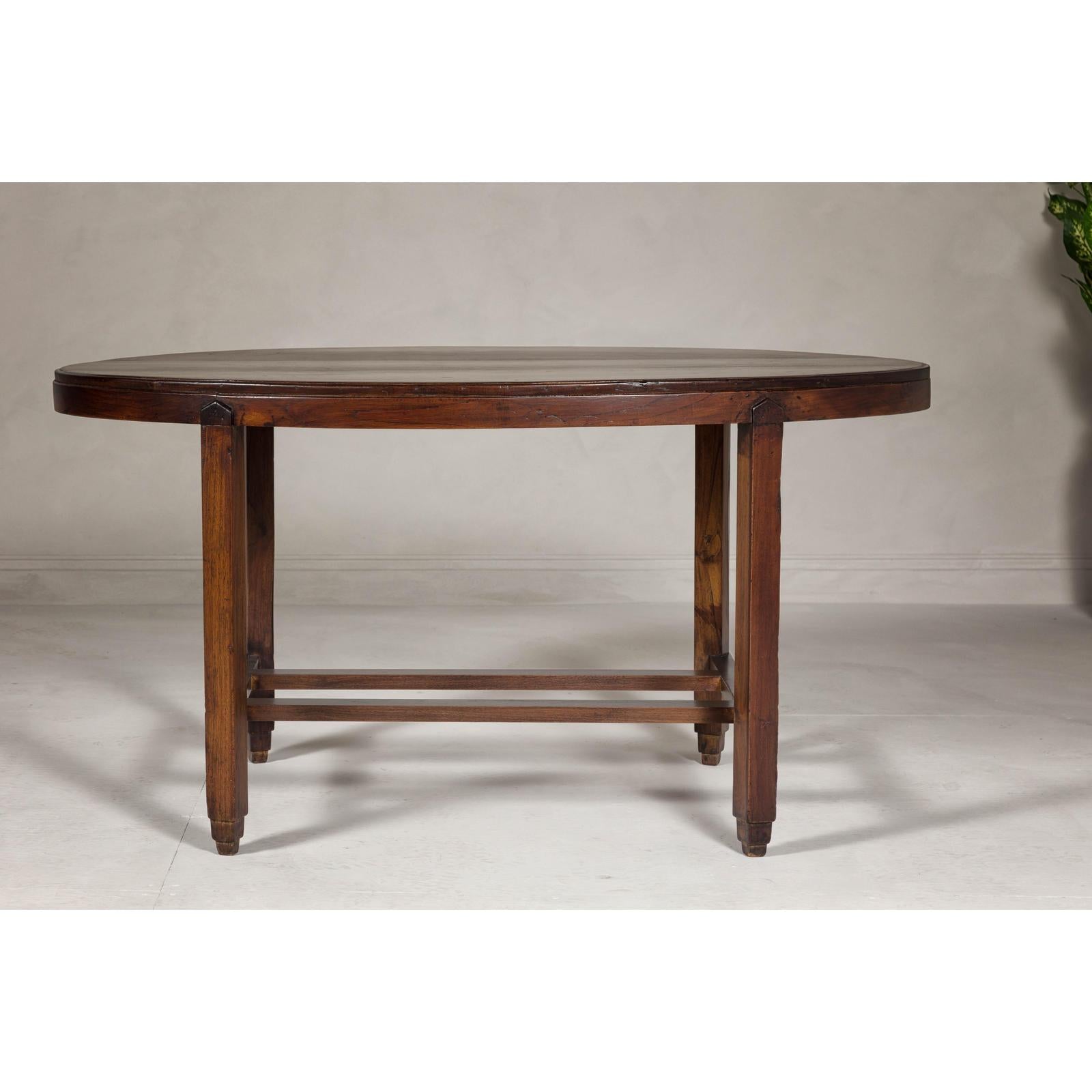 Oval Top Center Table with Inverted Stepped Pyramid Feet and Cross Stretcher