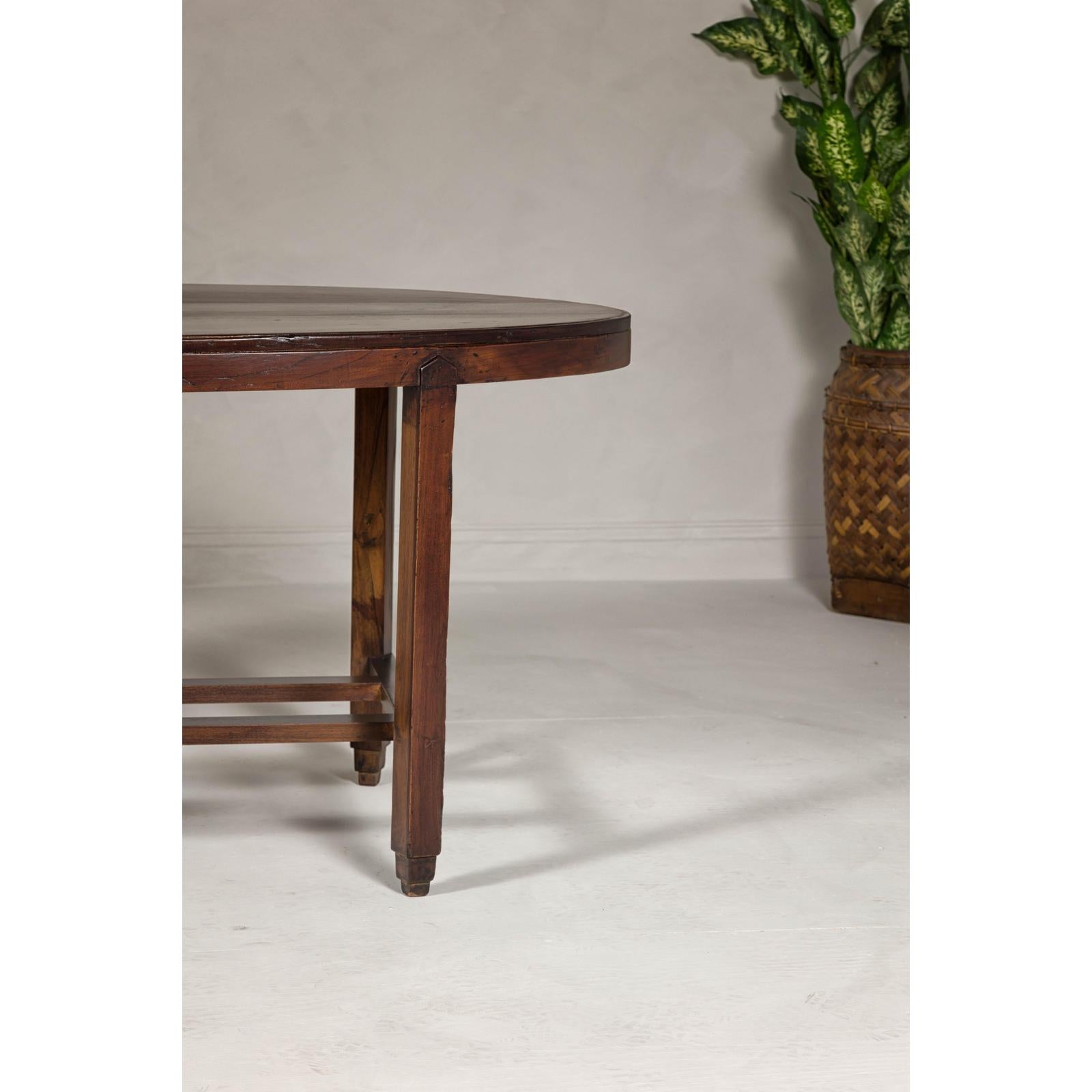 Oval Top Center Table with Inverted Stepped Pyramid Feet and Cross Stretcher
