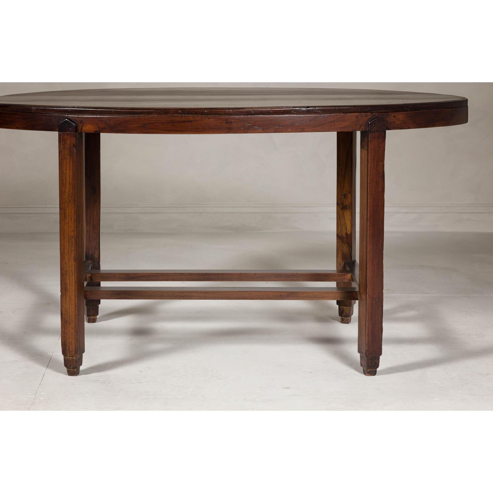 Oval Top Center Table with Inverted Stepped Pyramid Feet and Cross Stretcher