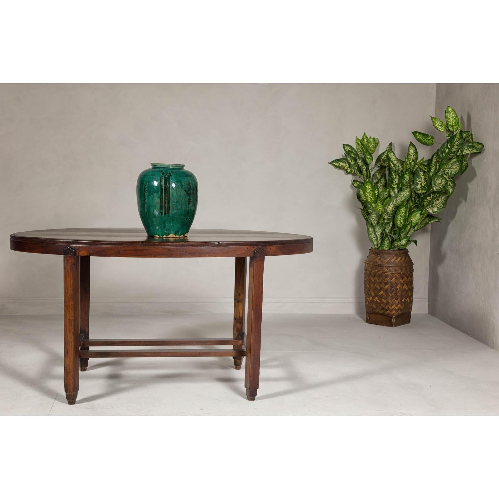 Oval Top Center Table with Inverted Stepped Pyramid Feet and Cross Stretcher