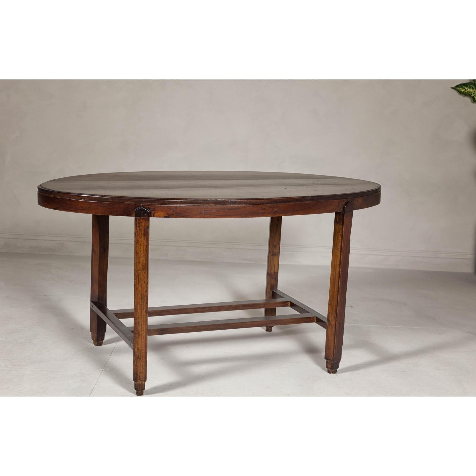 Oval Top Center Table with Inverted Stepped Pyramid Feet and Cross Stretcher