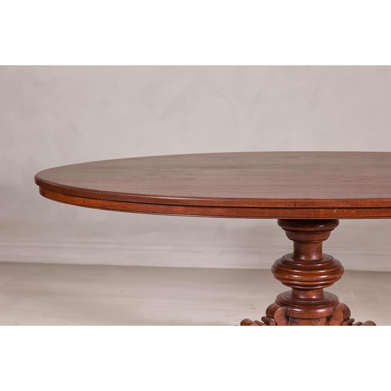 Dutch Colonial Oval Pedestal Dining Table with Scrolling Base, Late 19th Century