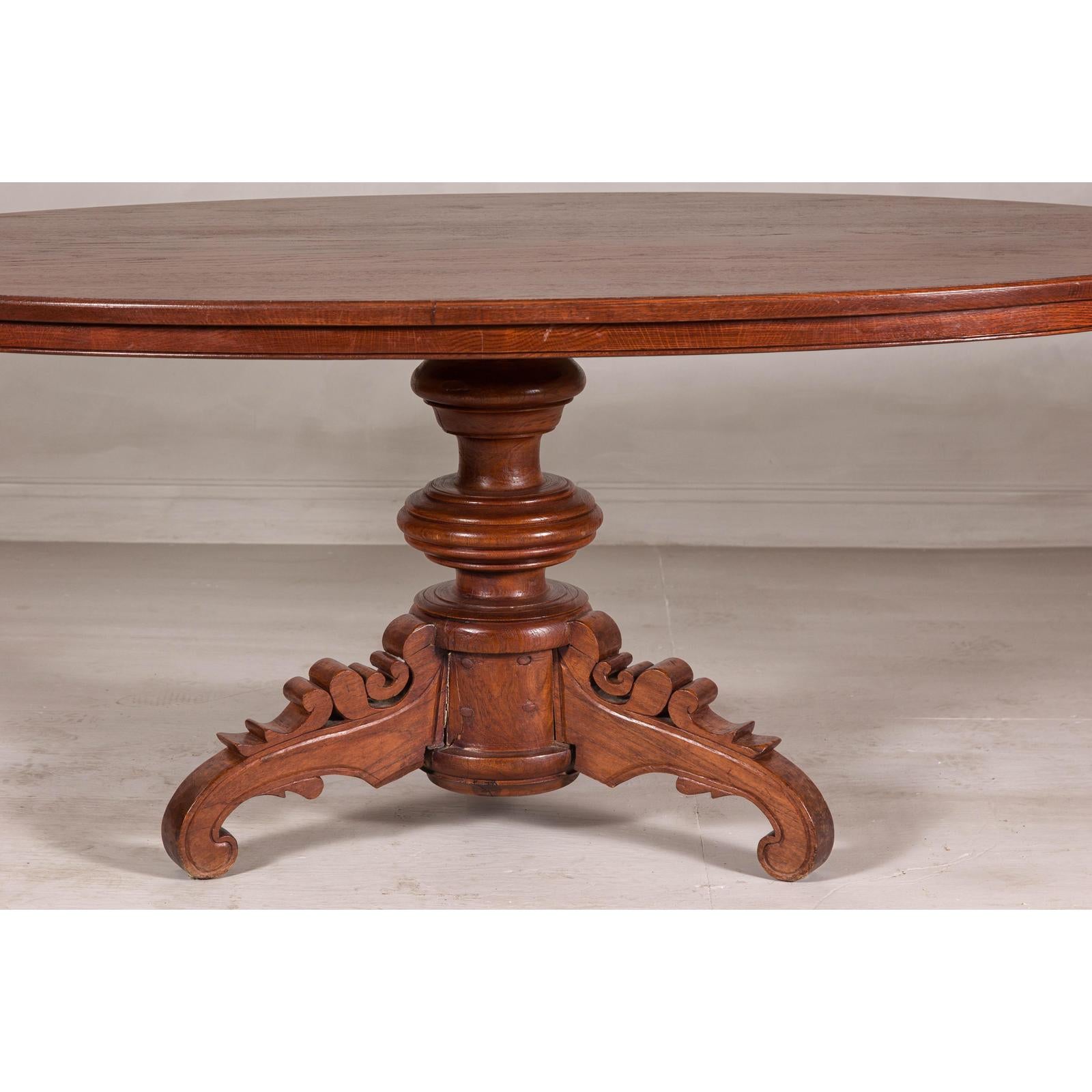 Dutch Colonial Oval Pedestal Dining Table with Scrolling Base, Late 19th Century