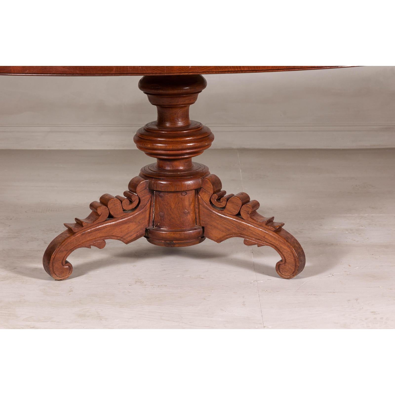 Dutch Colonial Oval Pedestal Dining Table with Scrolling Base, Late 19th Century