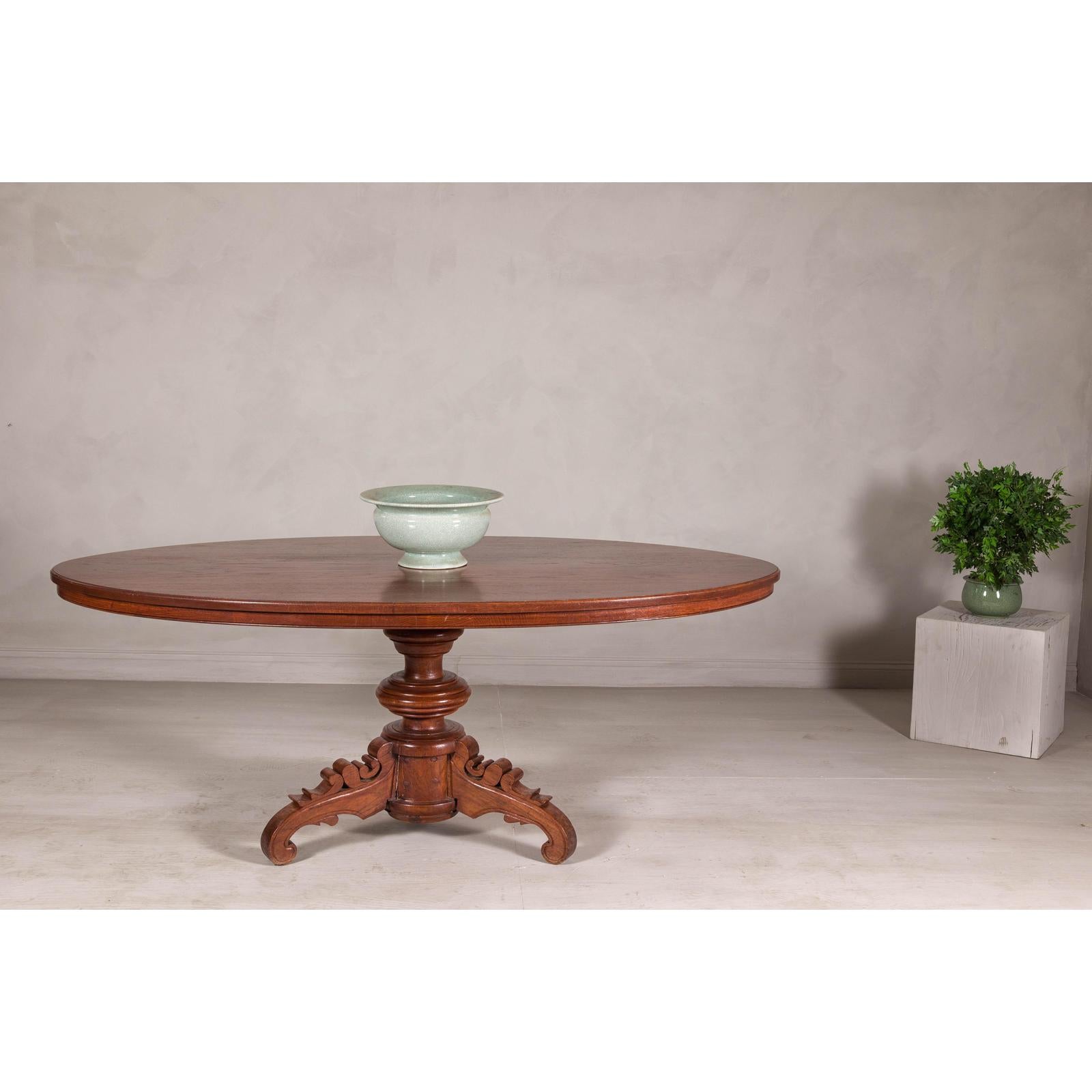 Dutch Colonial Oval Pedestal Dining Table with Scrolling Base, Late 19th Century