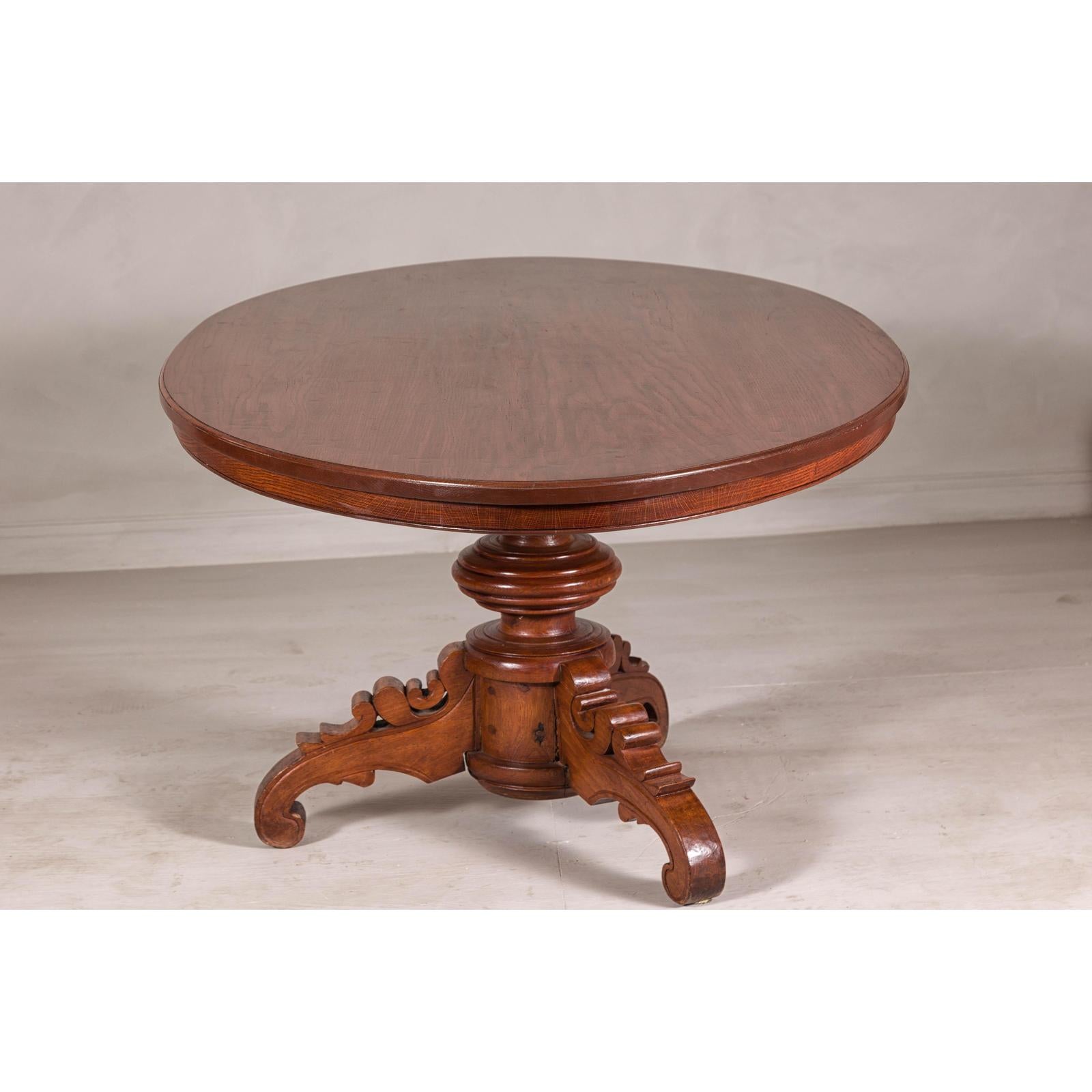 Dutch Colonial Oval Pedestal Dining Table with Scrolling Base, Late 19th Century