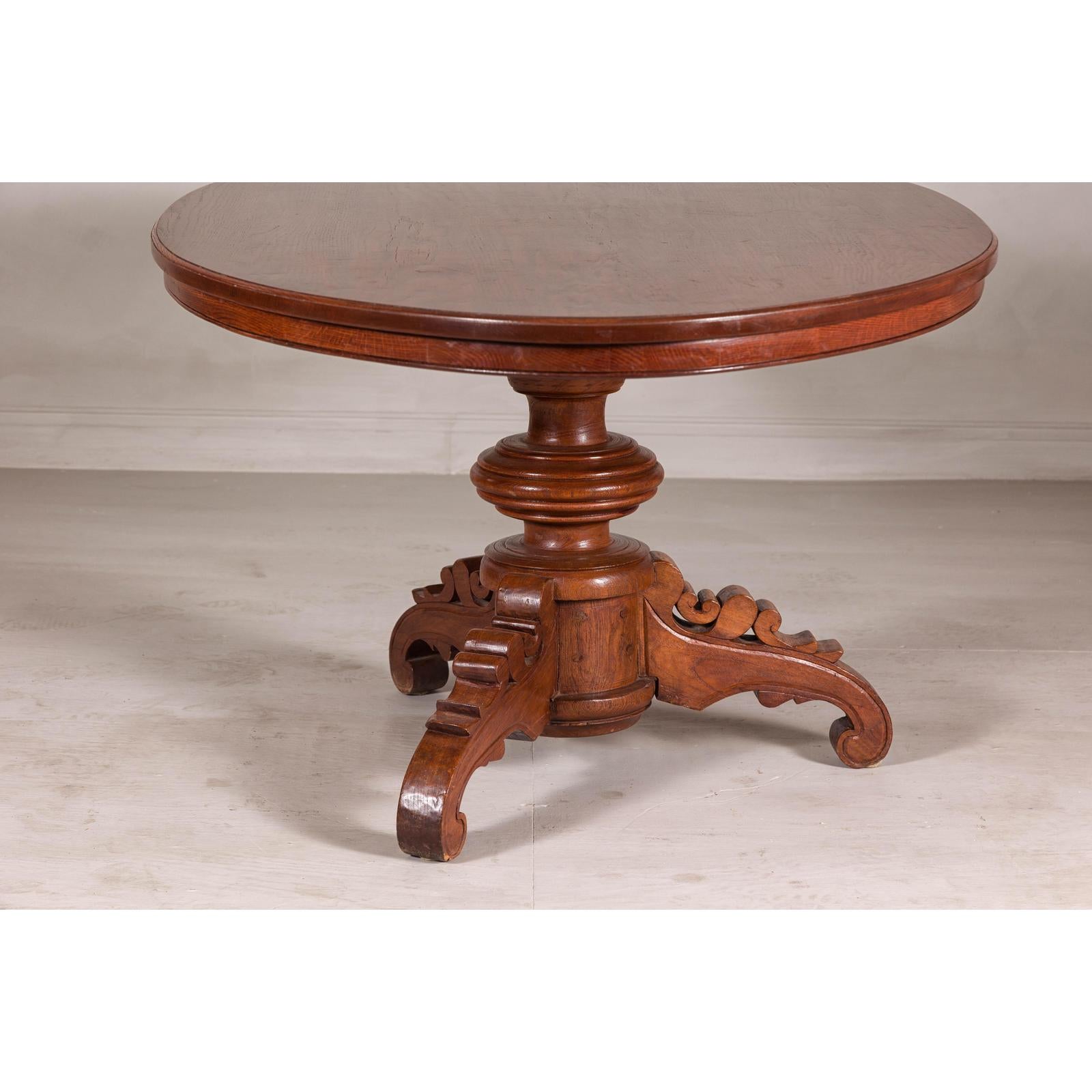 Dutch Colonial Oval Pedestal Dining Table with Scrolling Base, Late 19th Century
