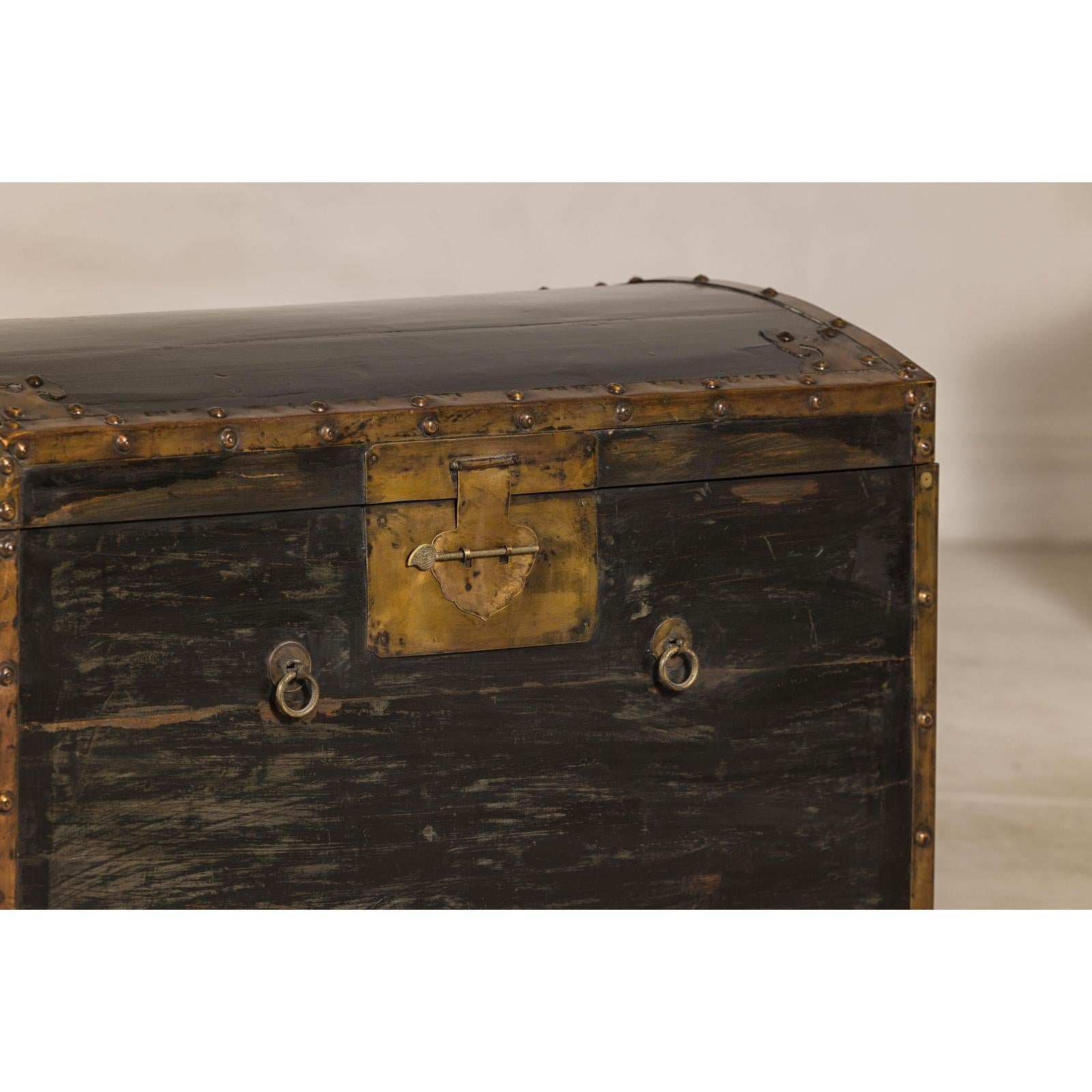 Antique Black and Gold Late Qing Dynasty Trunk with Curved Top and Brass Accents