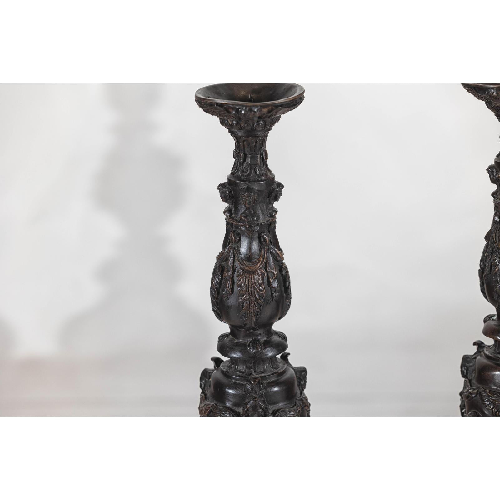 Baroque-Style Ornate Metal Candlesticks with Cherub, Volute and Garland Motifs