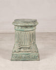 Verdigris bronze pedestal showing fluted shaft and palmette base