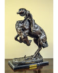 Bronze Frederic Remington "Rattlesnake" tabletop statue of cowboy on bucking horse, Western art style, on table.