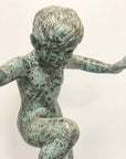 Bronze Snail Boy garden fountain featuring a young child with arms out, one knee raised, outdoor statue view.