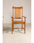 Teak Dutch Colonial armchairs with vertical slats on a light-colored floor.
