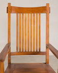 Close-up of teak armchair slatted back and curved arms