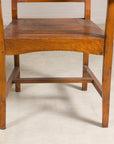 Close-up of teak armchair seat and turned front legs