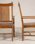 Pair of teak dining armchairs shown from rear and side