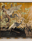 Gold-tone vintage Chinese four-panel screen with crane design on a light floor.