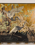 Painted crane screen displayed in an interior