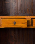 Close-up of two open drawers with brass hardware in an antique Chinese elm and burl wood cabinet.