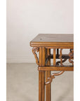 Close-up of a carved corner bracket and rounded tabletop edge