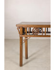 Left end view of the narrow console table and carved brackets