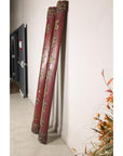 Angled view of paired red wood calligraphy panels showing their rounded profiles