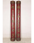 Side profile of paired red wood panels showing carved cylindrical forms