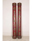 Pair of tall red and gilt Chinese calligraphy panels displayed against a pale wall