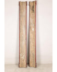 Detail of aged red finish and raised gilt characters on Chinese wood panels