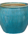 Turquoise glazed stoneware planter on white background