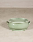 Celadon ceramic footbath shown at smaller scale in a studio setting