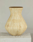 Beige ceramic vase with textured drip glaze and flared neck on a square pedestal.