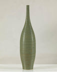 Olive-green ribbed ceramic artisan vase on white surface.