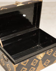 Open black lacquered chest showing interior storage