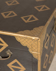 Close-up of lacquered chest corner and metal handle