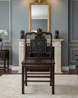 Brown lacquered yumu wood side chair with hand-carved details and a square floral backrest.